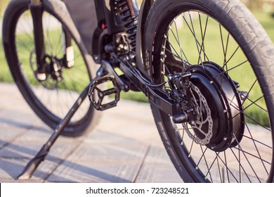 Electric Bike Motor Wheel Close Up With Pedal And Rear Shock Absorber. Ebike Bicycle Environmentally Friendly Eco E-mountainbike Transport. Healthy Lifestyle