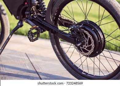 Electric Bike Motor Wheel Close Up With Pedal And Rear Shock Absorber. Ebike Bicycle Environmentally Friendly Eco E-mountainbike Transport. Healthy Lifestyle