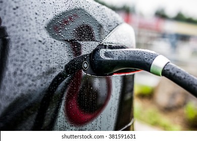 Electric Black Car charging at an Electric petrol charging station - E-Mobility