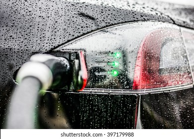 Electric Black Car charging at an Electric petrol charging station - E-Mobility