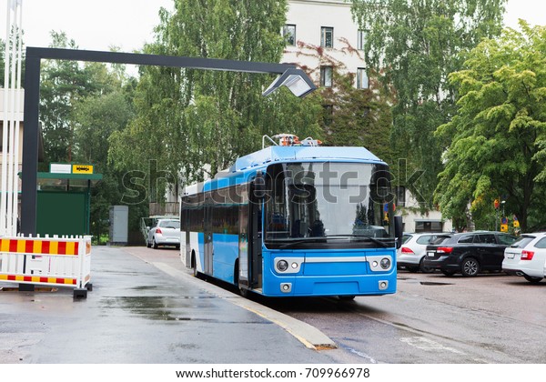 Electric bus at a stop is charged by wireless
induction charging