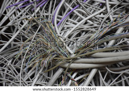 Electric cabels of multiple colors - mountain of old used cables with frayed ends - Inside an old fabric