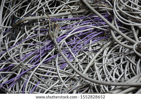 Electric cabels of multiple colors - mountain of old used cables with frayed ends - Inside an old fabric