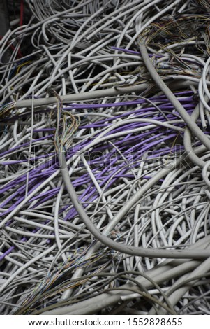 Electric cabels of multiple colors - mountain of old used cables with frayed ends - Inside an old fabric