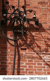 electric cable that attached to the red brick wall of Saigon Cathedral