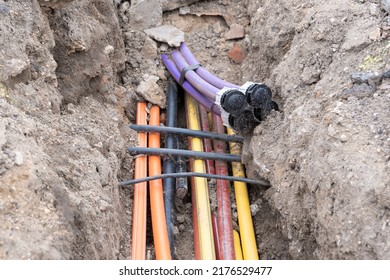 Electric Cable Underground. Broadband And Power Lines In Various Colors And Types Of Tube. Connection Work On Construction Building Site. 