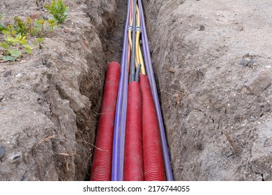 Electric Cable Underground. Broadband And Power Lines In Various Colors And Types Of Tube. Connection Work On Construction Building Site. 