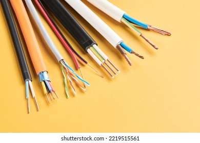 Electric cables, many copper wires with colored isolation isolated on yellow background