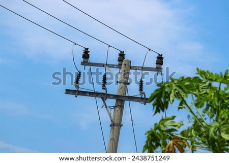 Electric cables are messy on electricity poles. Blue sky negative space home telephone cables with messy and neatly arranged pole cables.