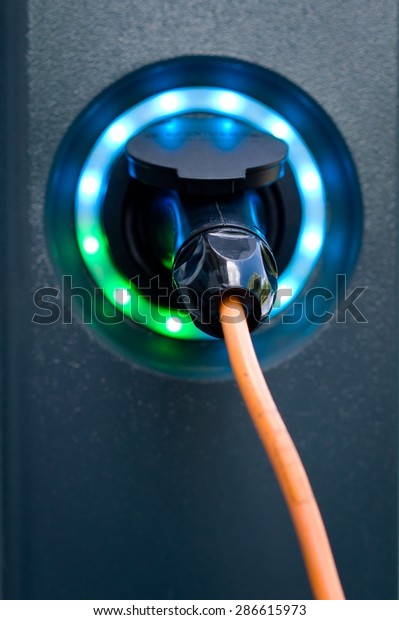 Electric car battery charger socket with load\
indicator lights, selective\
focus