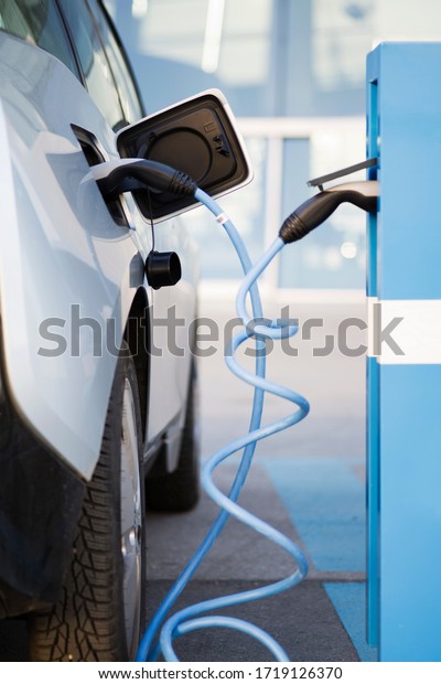 \
An\
electric car is being charged at a charging\
station