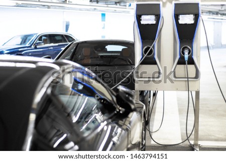 
An electric car is charged at a charging station