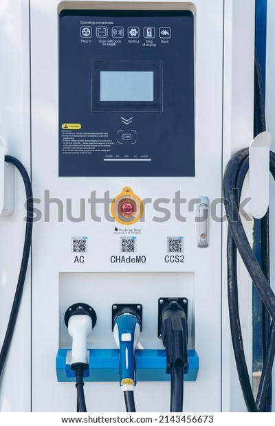 Electric car\
charger EV battery commuter station spot.\
Plug for vehicle with\
electric engine. Modern Clean and Green power energy With Future.\
Pitsanulok,Thailand Jan\
15,2022