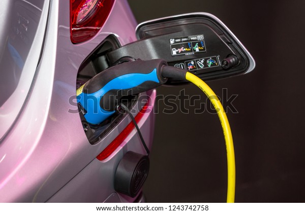 Electric car charger, The process of charging\
an electric vehicle. Electric car\
socket.