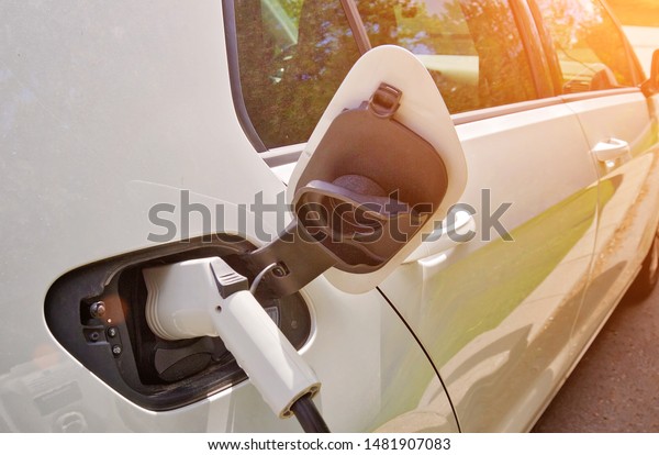 Electric car charging the battery from the\
electric charger