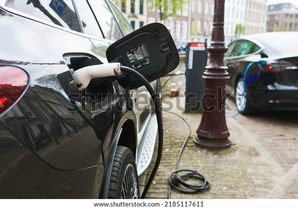 Electric Car Charging. Charger connector plugged to\
Electric auto