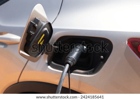 Electric car charging. Energy renewal. Wind Farm.