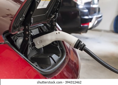 Electric Car Charging In A House Garage With Home Charger.