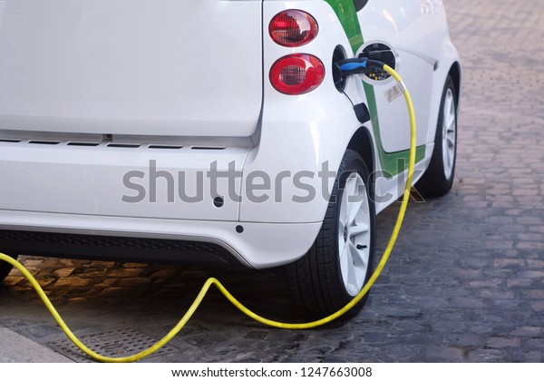 electric car is charging from a\
mobile power station, the theme of charging technology and\
industry\
