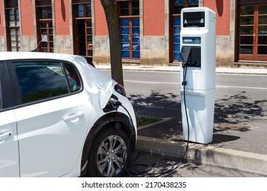electric car charging at a modern gas station on a sunny day - Shutterstock ID 2170438235