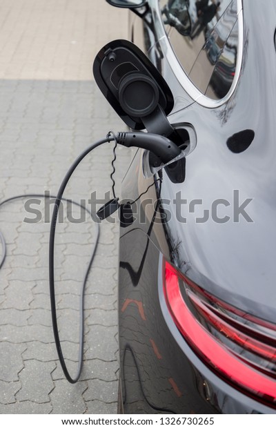 Electric car  charging on charge station –\
electro mobility environment friendly \
