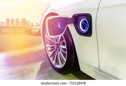 Electric Car Charging On Parking Lot With Electric Car Charging Station / Electric Cars In The Row Ready For Drive.	