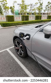 Electric car is charging in parking lot - Shutterstock ID 2253446281