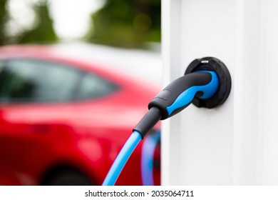 Electric Car Charging At Plug In Charge Station In A Public Car Park In Suffolk, UK