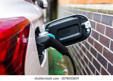 Electric Car Charging At Plug In Charge Station In A Public Car Park In Suffolk, UK