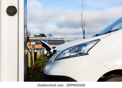 Electric Car Charging At Plug In Charge Station In A Public Car Park In Suffolk, UK