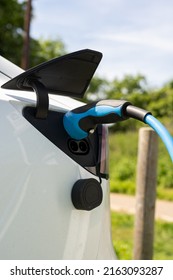 Electric Car Charging At Plug In Charge Station In A Public Car Park In Suffolk, UK