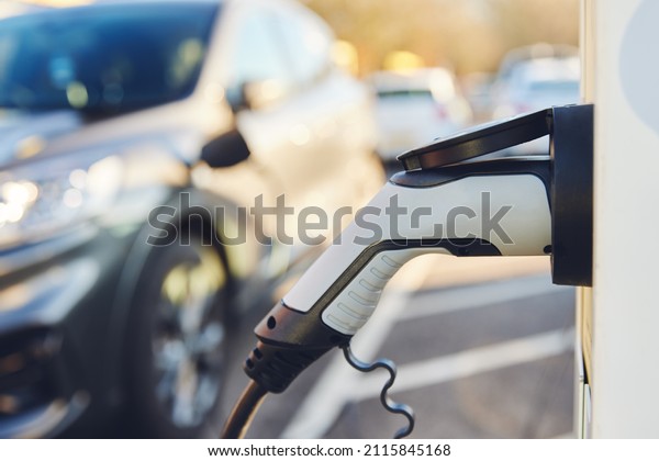Electric Car\
Charging Point with electric car\
behind