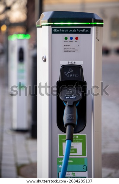 Electric car charging point\
in Sweden. Green energy and zero emission topic. Stockholm, Sweden\
2021.11.30