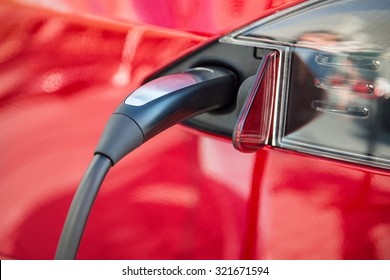 electric car charging process by power cable supply plugged in