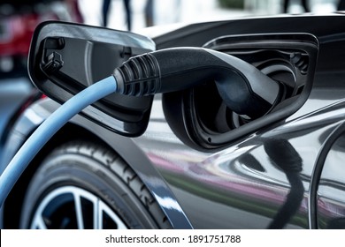 Electric car at charging station - Shutterstock ID 1891751788