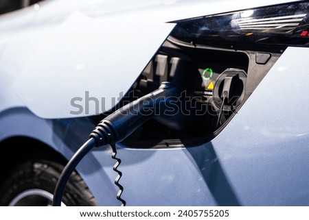 Electric car is charging at charging station