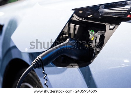 Electric car is charging at charging station
