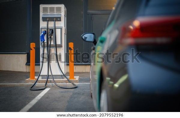 Electric car\
charging station and electric\
car.