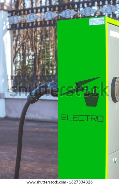 Electric Car\
Charging station. Battery hybrid vehicle eco charger. Future energy\
power. Green technology. Transport plug. Fuel recharge. Clean\
ecology concept. Selective\
focus.