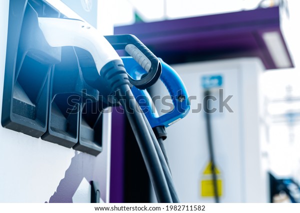 Electric car charging station for charge EV\
battery. Plug for vehicle with electric engine. EV charger. Clean\
energy. Charging point at car parking lot. Alternative energy.\
Future transport\
technology