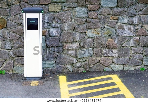 Electric car charging station for charge EV\
battery. Plug for vehicle with electric engine. EV charger. Clean\
energy. Charging point at car parking lot. Alternative energy.\
Future transport\
technology