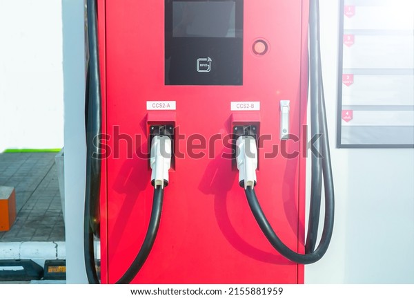 Electric car charging station for\
charge EV battery. Plug for vehicle with electric engine. EV\
charger.  parking lot. Future transport\
technology.
