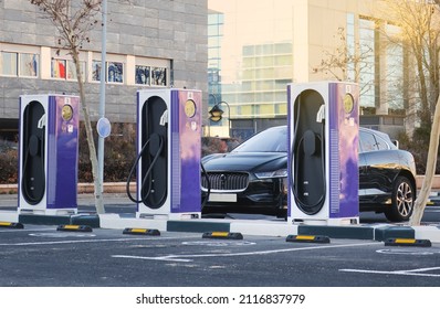 Electric car charging station with EV car parked and refueling