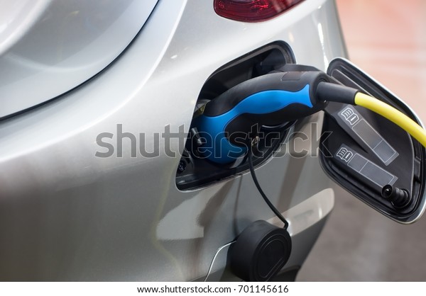 Electric car charging with\
station, EV fuel advance and modern eco system, Save the earth\
conception.