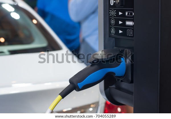 Electric car charging with\
station, EV fuel advance and modern eco system, Save the earth\
conception.