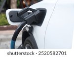 Electric car charging station. Hybrid car Electric charger station in the Car Park. Electric car charging on parking and charging station. Electric socket. Transportation EV	