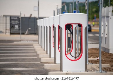 Electric car charging station, parking for electric and hybrid vehicles with chargers. Network of electric charging stations. - Shutterstock ID 2167616497