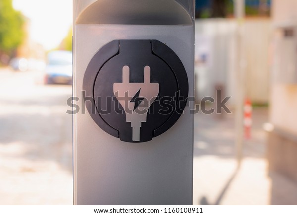 Electric car charging station. Plug for vehicle\
with electric motor. Clean energy power. Charging station. Charging\
point. Infrastructure\
policy.