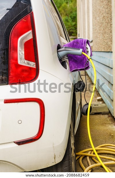 Electric\
car at charging station with power outlet. Ecological\
transportation. Automotive technology\
concept.