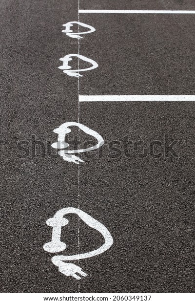 Electric car charging\
symbol on a parking